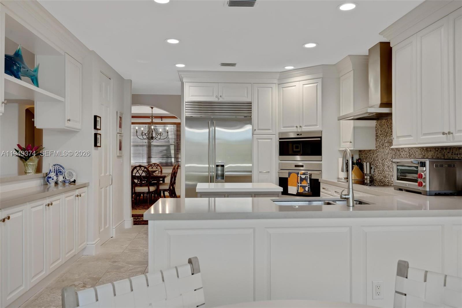 205 South Harbor Drive Key Largo, FL 33037 - Photo 33 of 50 a kitchen with stainless steel appliances a sink a refrigerator and cabinets