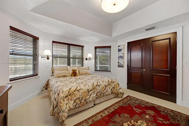 a bedroom with a large bed and a dresser