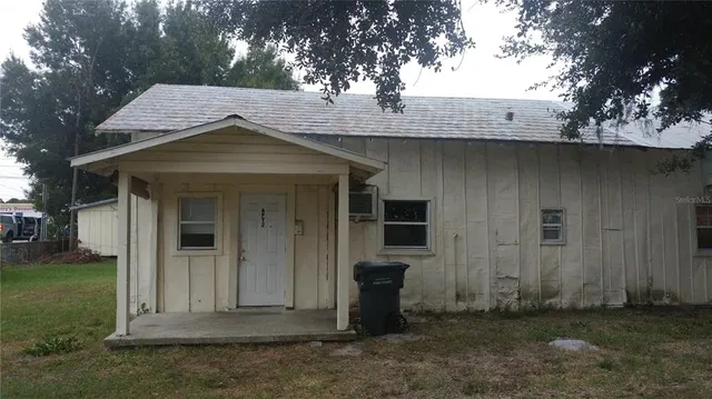 a view of a wooden house with a yard