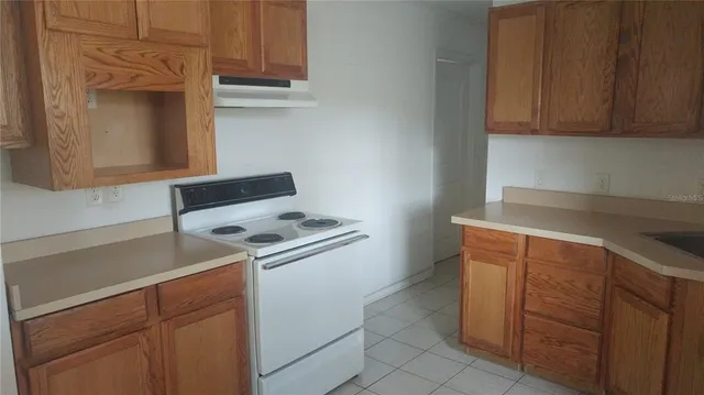 a kitchen with cabinets and a stove