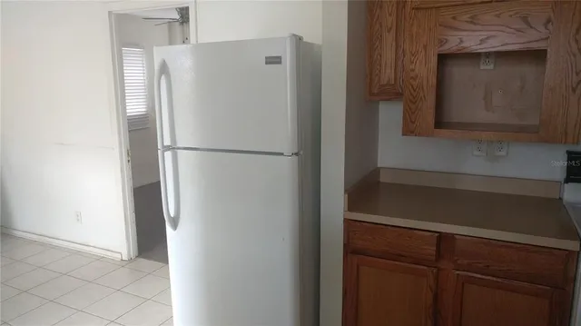 a white refrigerator freezer sitting in a kitchen