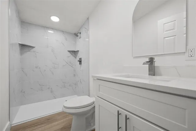 a bathroom with a sink a toilet and shower