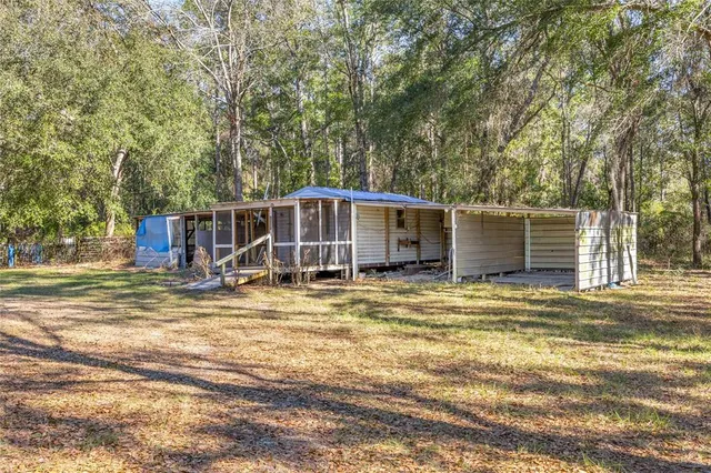 a view of a house with a yard and sitting area