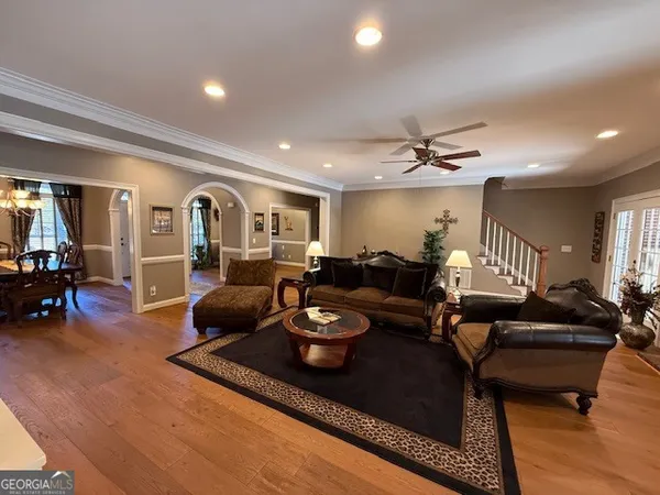 a bedroom with a bed and a flat tv screen on dresser