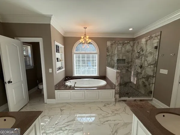 a bedroom with furniture and a chandelier