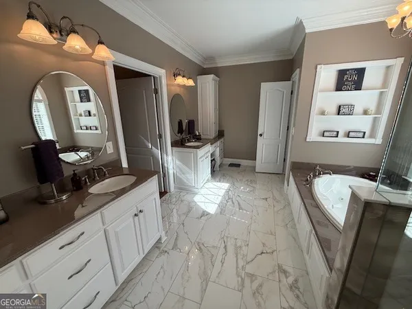 a bedroom with a bed a chair and potted plant on the dresser