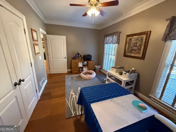 a bedroom with bed and a chandelier