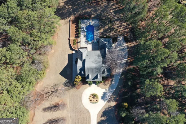 a kitchen with granite countertop a sink a counter space appliances and cabinets