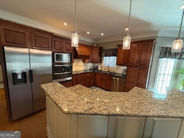 a dining room with furniture a chandelier and wooden floor