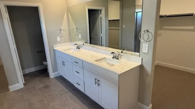 a bathroom with a double vanity sink and a mirror