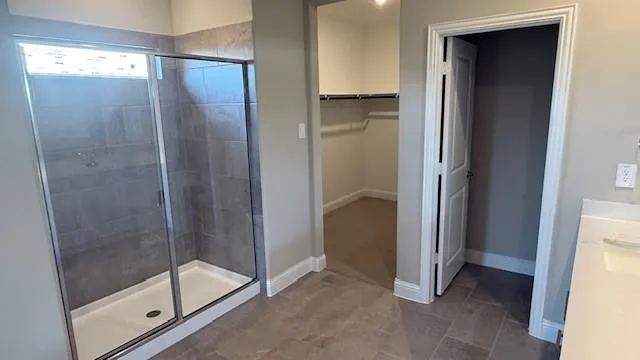 a bathroom with a glass shower door