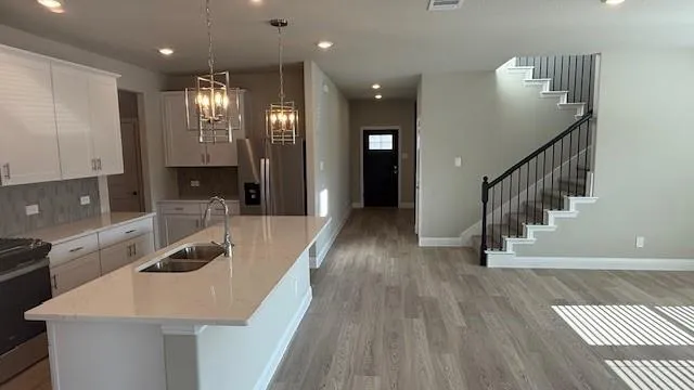 a kitchen with counter top space a sink and cabinets