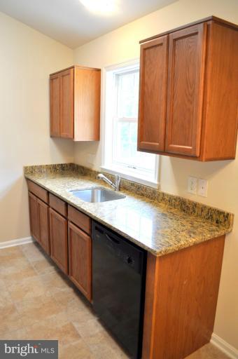 a kitchen with a sink cabinets and a window