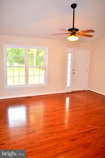 2220 Partlow Road Beaverdam, VA 23015 - Photo 17 of 24 a view of empty room with wooden floor and fan
