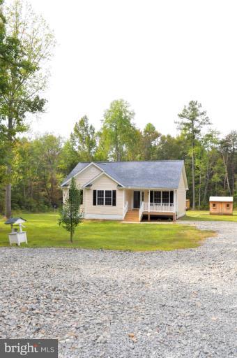 2220 Partlow Road Beaverdam, VA 23015 - Photo 20 of 24 a front view of a house with a yard and a garage
