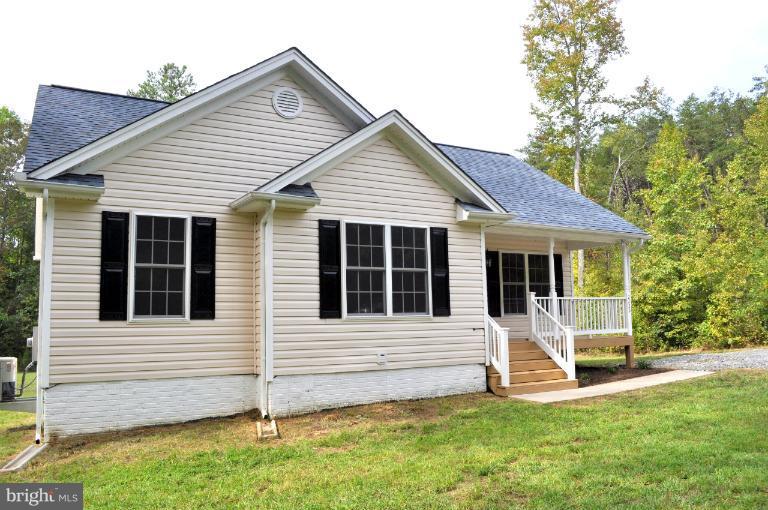 2220 Partlow Road Beaverdam, VA 23015 - Photo 6 of 24 a view of a house with a yard and fence