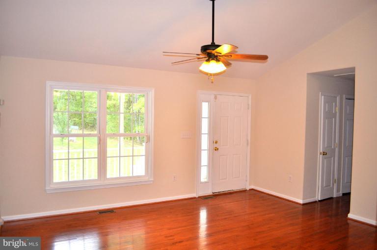 2220 Partlow Road Beaverdam, VA 23015 - Photo 8 of 24 a view of an empty room with wooden floor and windows