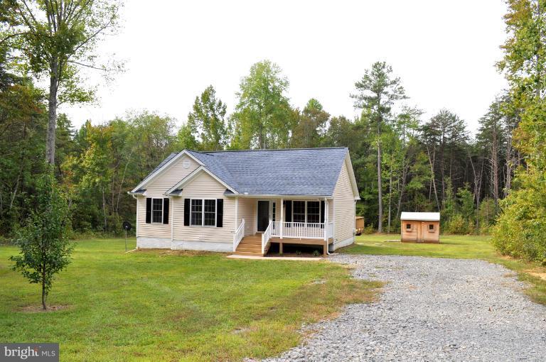 2220 Partlow Road Beaverdam, VA 23015 - Photo 9 of 24 a front view of a house with a garden and trees