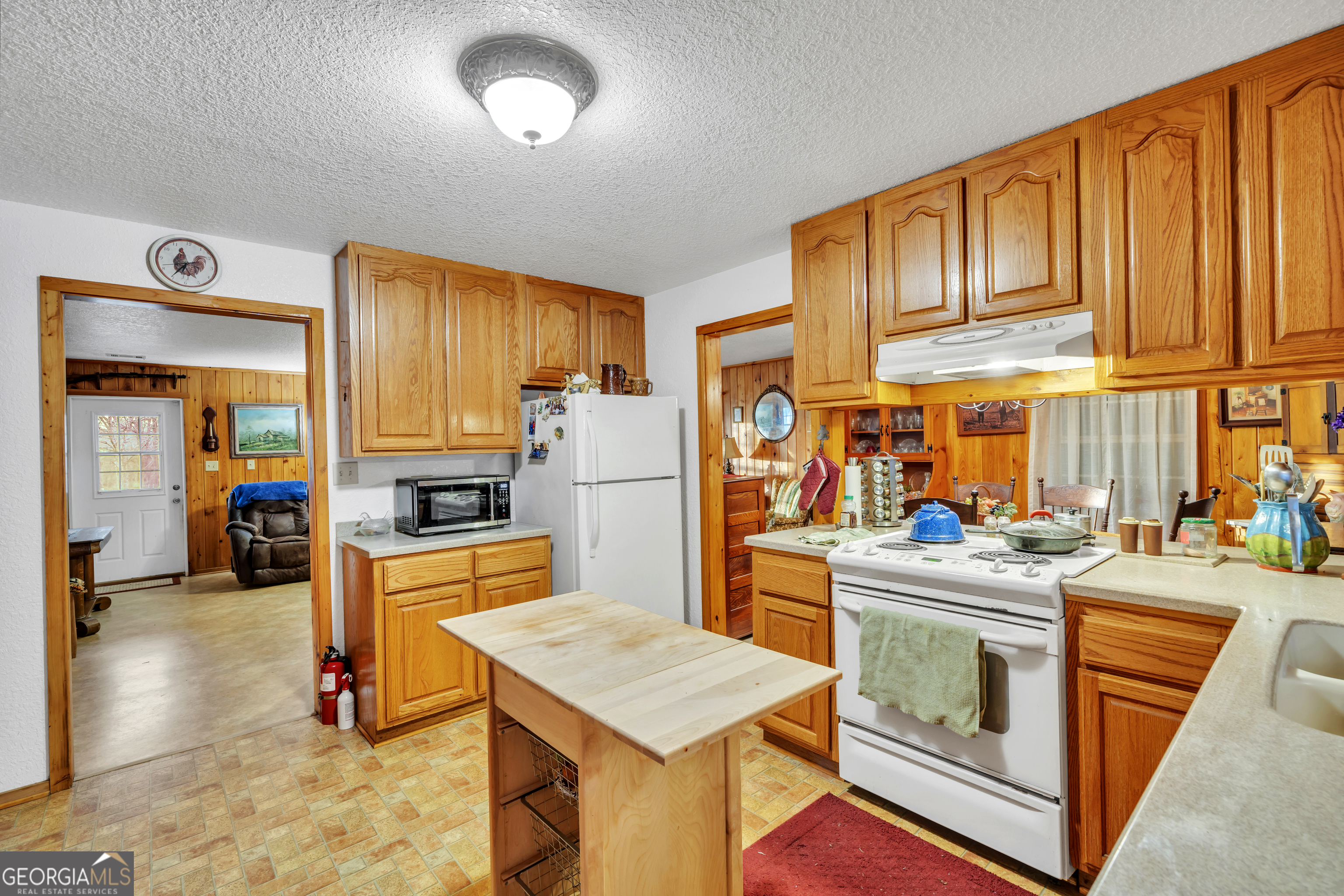 241 Foskey Cemetery Road Adrian, GA 31002 - Photo 24 of 95 a kitchen that has a lot of cabinets in it and wooden floors