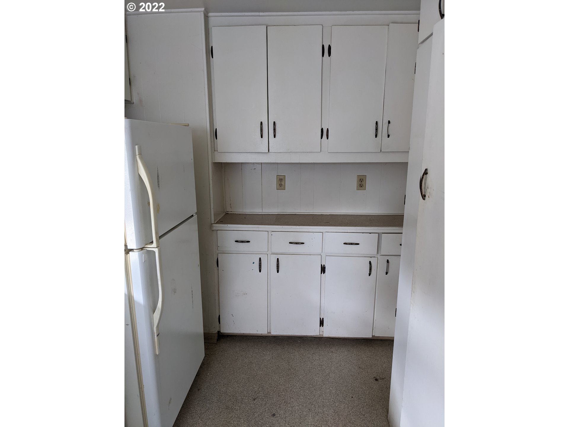 610 Southwest 6th Street Pendleton, OR 97801 - Photo 15 of 31 a kitchen with white cabinets and a refrigerator