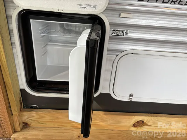 a view of a wooden house with large trees