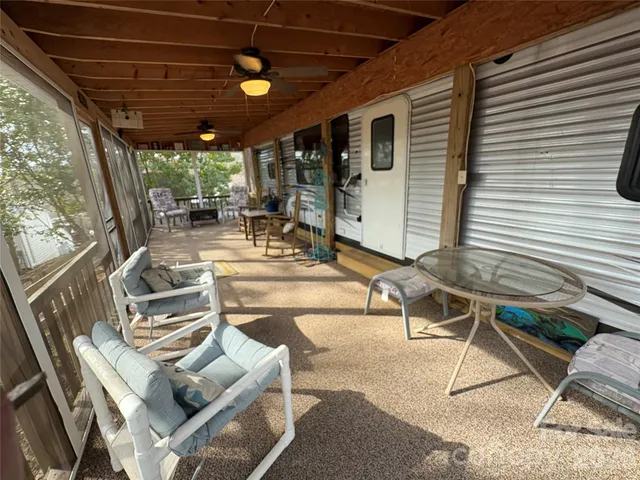 a view of a patio with table and chairs and potted plants