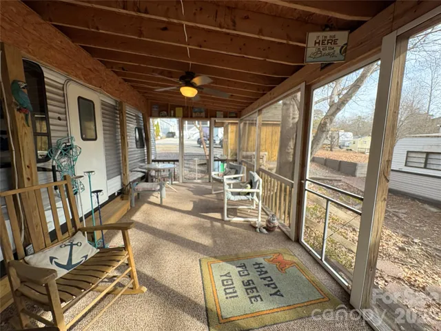 a view of a living room with furniture and a floor to ceiling window
