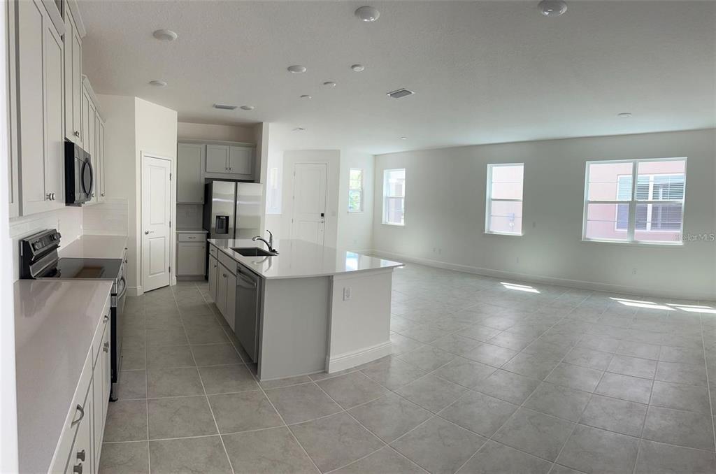 4806 Prairie Preserve Run St. Cloud, FL 34772 - Photo 3 of 13 a kitchen with a refrigerator and a sink
