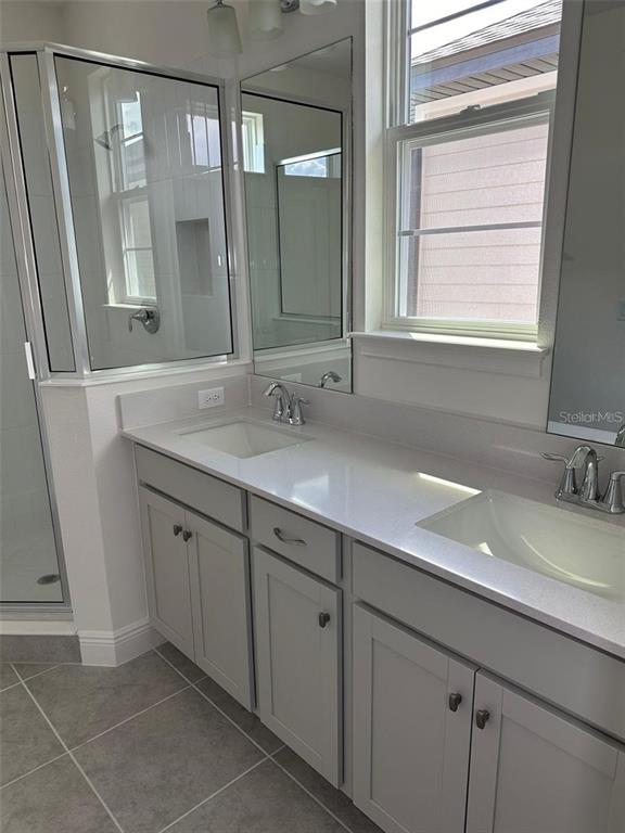4806 Prairie Preserve Run St. Cloud, FL 34772 - Photo 5 of 13 a bathroom with a double vanity sink and a mirror