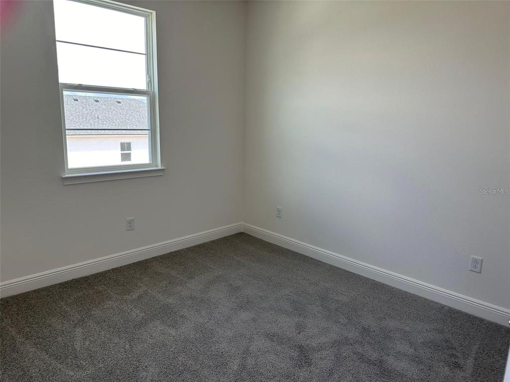 4806 Prairie Preserve Run St. Cloud, FL 34772 - Photo 8 of 13 an empty room with a window