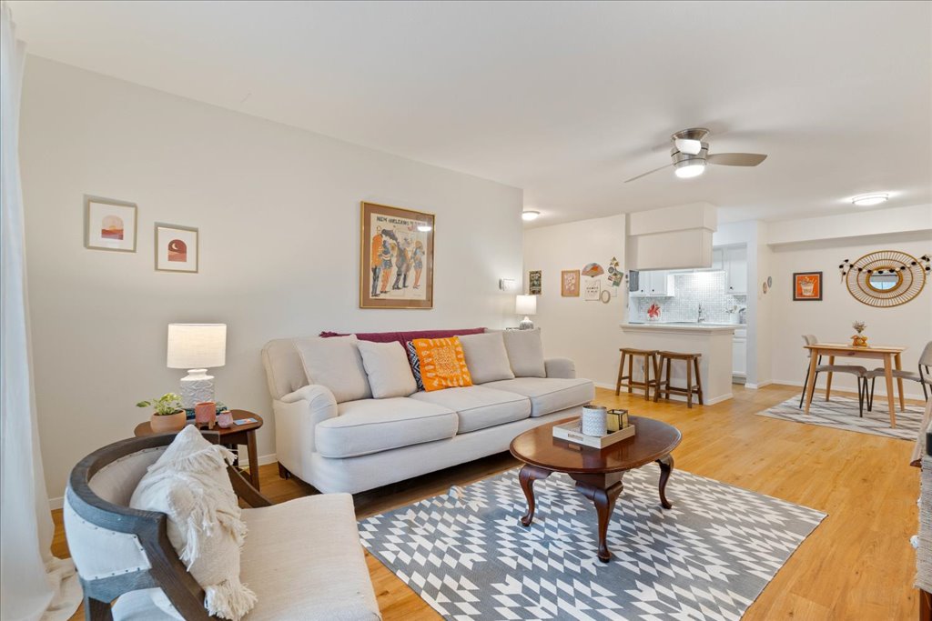 a living room with furniture a rug and a chandelier