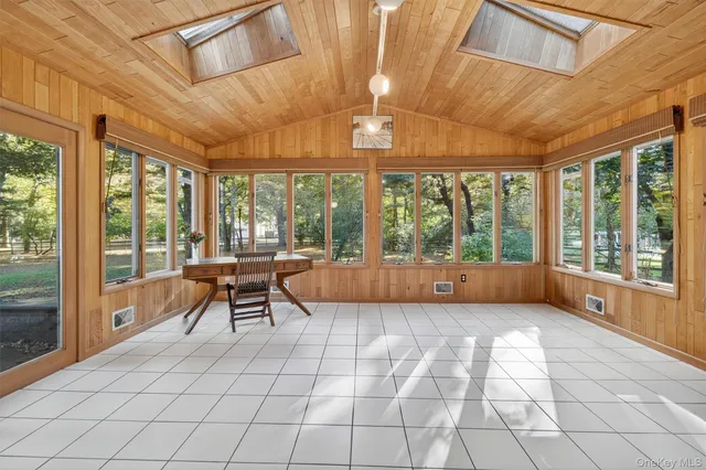 a view of a room with furniture and large windows