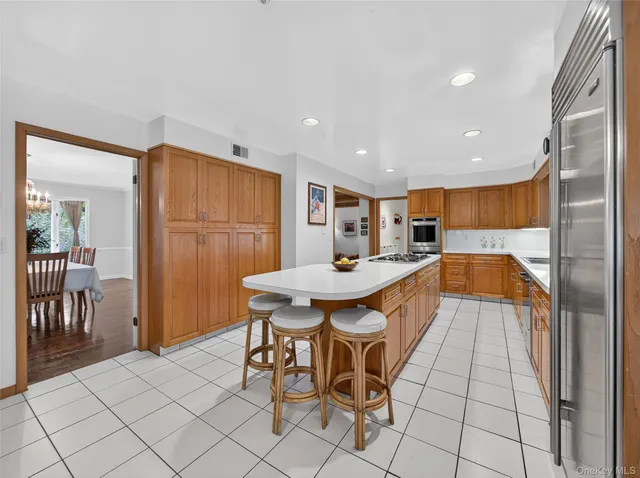 a large kitchen with a table and chairs