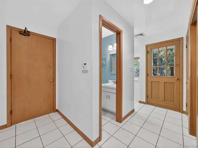 a view of a hallway to rooms