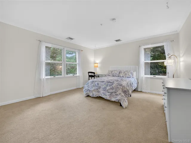 a bedroom with a bed lamp and window