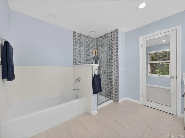 a bathroom with a bathtub and a shower