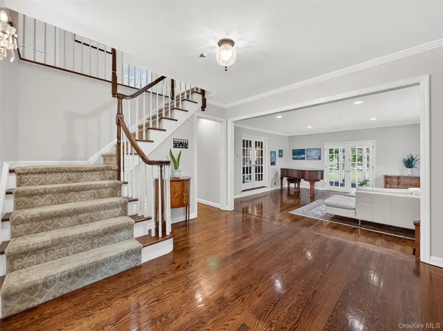 a view of entryway livingroom and hall with wooden floor