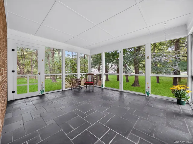 a view of a backyard with porch and garden