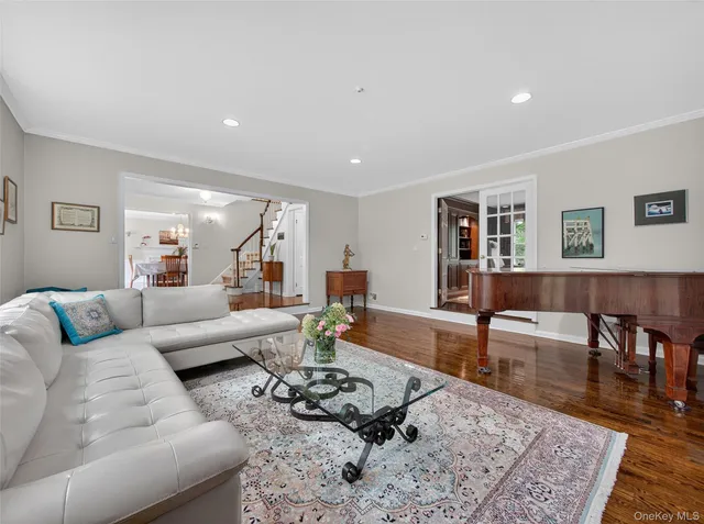 a living room with furniture a couch and wooden floor