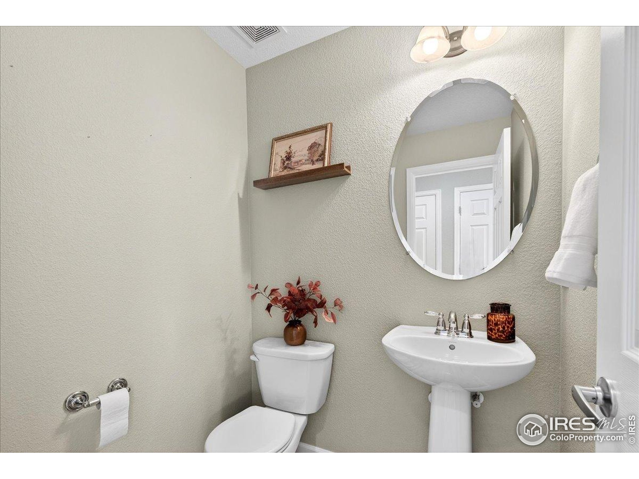 210 Saxony Road Johnstown, CO 80534 - Photo 11 of 28 a bathroom with a sink and a mirror