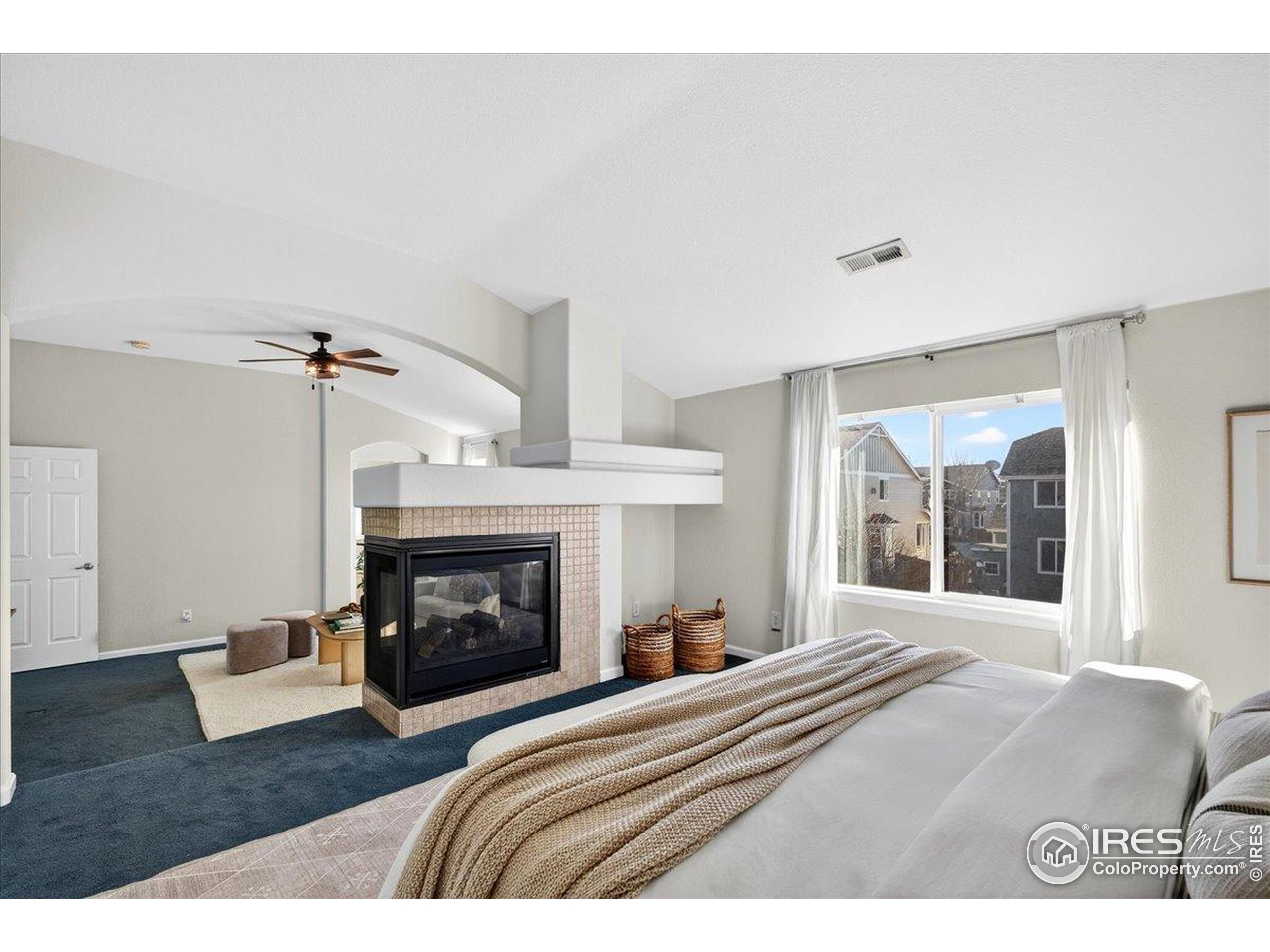 210 Saxony Road Johnstown, CO 80534 - Photo 15 of 34 a bedroom with a bed and a fireplace