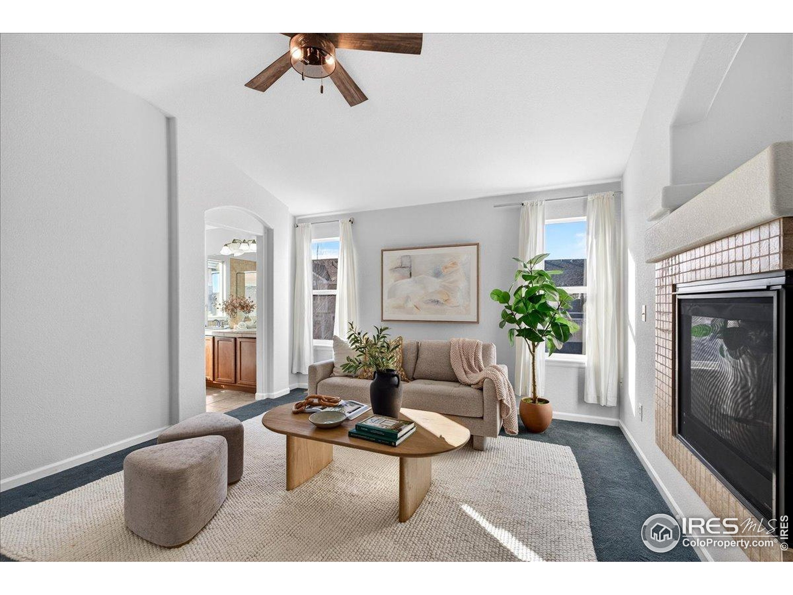 210 Saxony Road Johnstown, CO 80534 - Photo 16 of 34 a living room with furniture and a fireplace