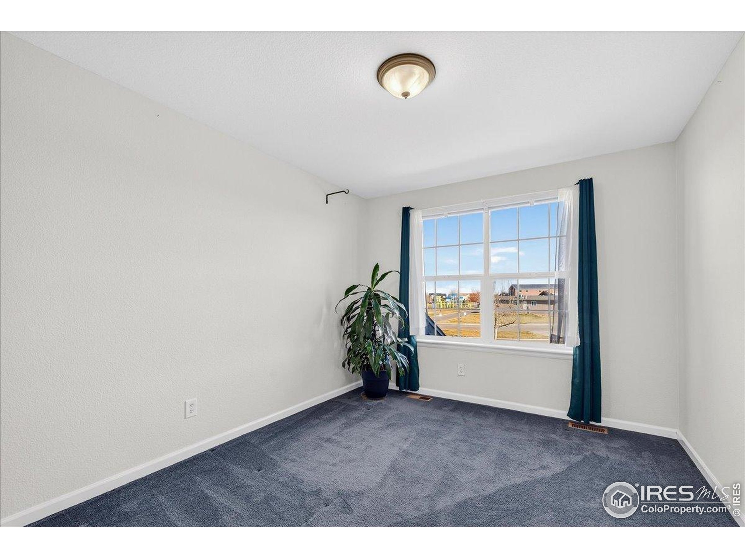 210 Saxony Road Johnstown, CO 80534 - Photo 16 of 28 a view of a livingroom and window