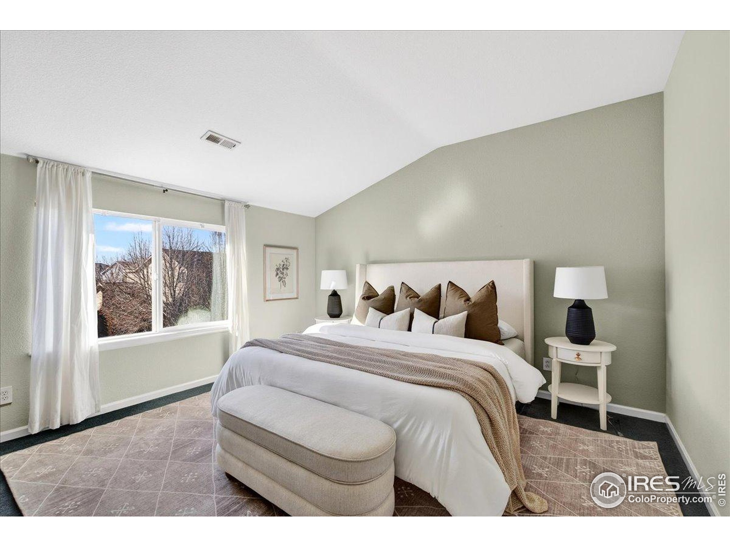 210 Saxony Road Johnstown, CO 80534 - Photo 4 of 28 a bedroom with a bed and a painting on the wall