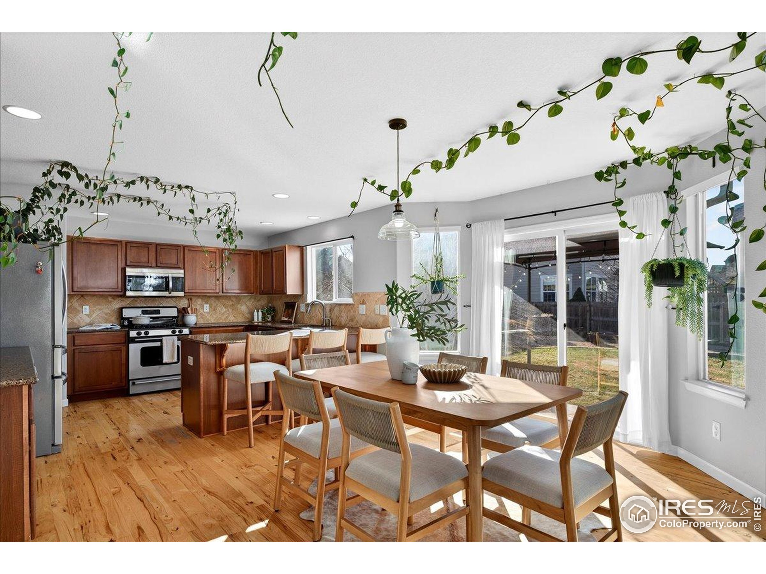 210 Saxony Road Johnstown, CO 80534 - Photo 5 of 34 a view of a dining room with furniture window and wooden floor
