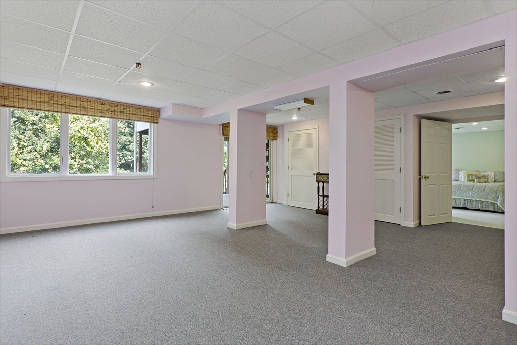 8 Chippers Lane, Unit 390 Mashpee, MA 02649 - Photo 21 of 38 an empty room with windows and closet