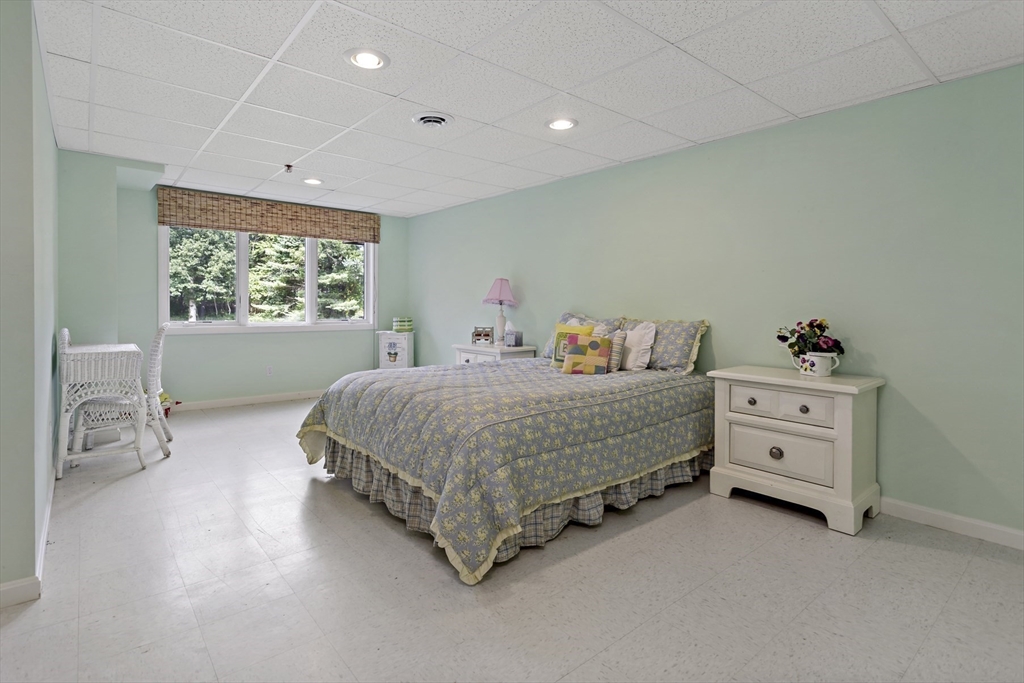 8 Chippers Lane, Unit 390 Mashpee, MA 02649 - Photo 22 of 38 a bedroom with a bed and a window