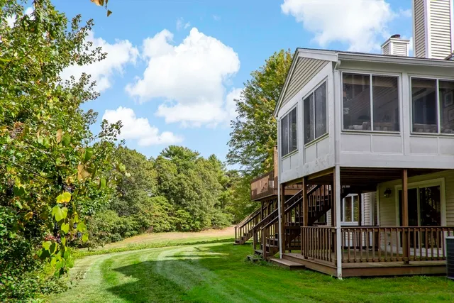 a view of small house with yard in front of it