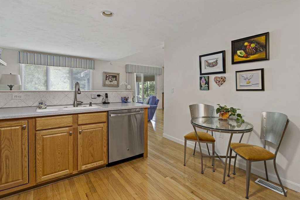 8 Chippers Lane, Unit 390 Mashpee, MA 02649 - Photo 7 of 38 a kitchen with stainless steel appliances granite countertop a sink and a refrigerator