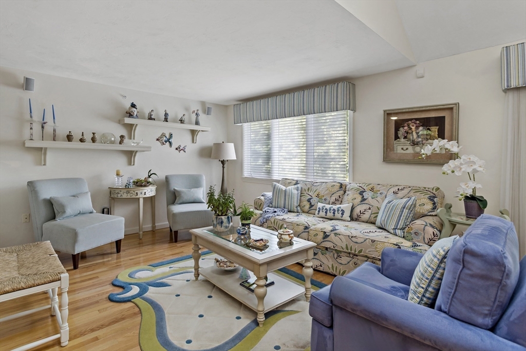 8 Chippers Lane, Unit 390 Mashpee, MA 02649 - Photo 8 of 38 a living room with furniture and a large window